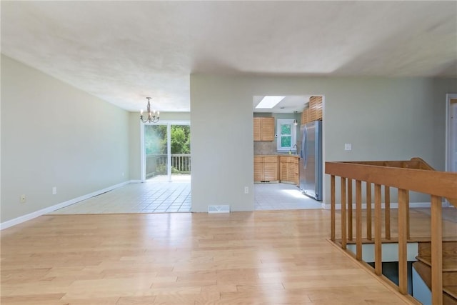 5 Spirketing St, Jamestown, RI 02835 - unfurnished room featuring a chandelier, light wood finished floors, and plenty of natural light