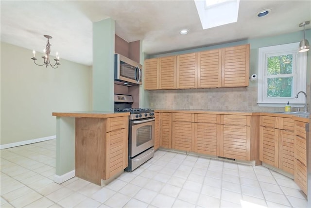5 Spirketing St, Jamestown, RI 02835 - kitchen featuring stainless steel appliances, light brown cabinetry, light countertops, a chandelier, and hanging light fixtures