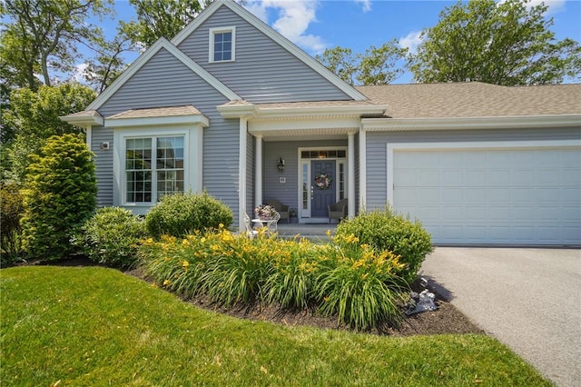 170 Providence Pike Unit 145, North Smithfield, RI 02896 - view of front of house featuring a porch, a front yard, an attached garage, asphalt driveway, and a shingled roof