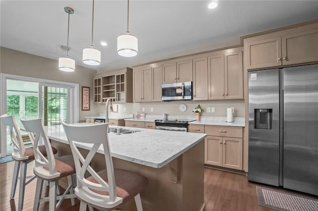 170 Providence Pike Unit 145, North Smithfield, RI 02896 - kitchen featuring stainless steel appliances, dark wood-style flooring, a kitchen breakfast bar, an island with sink, and decorative light fixtures