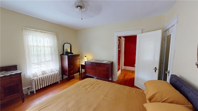 95 Burlington St, Providence, RI 02906 - bedroom featuring radiator heating unit, wood finished floors, and ceiling fan