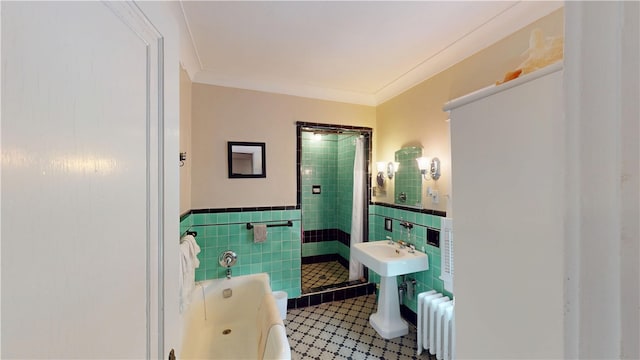 95 Burlington St, Providence, RI 02906 - bathroom with tile walls, radiator, a bath, a wainscoted wall, and a stall shower