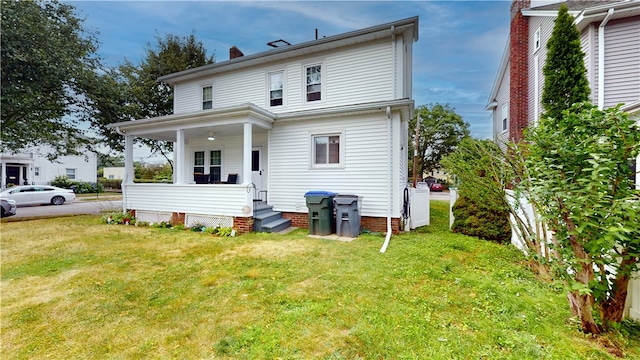 95 Burlington St, Providence, RI 02906 - back of house with a lawn, covered porch, and a chimney