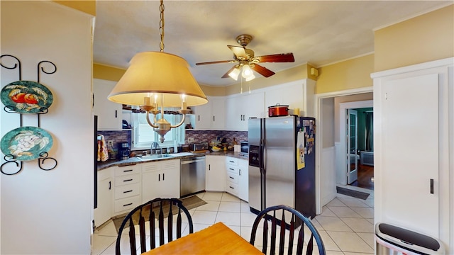 95 Burlington St, Providence, RI 02906 - kitchen with stainless steel appliances, dark countertops, backsplash, ceiling fan, and white cabinetry