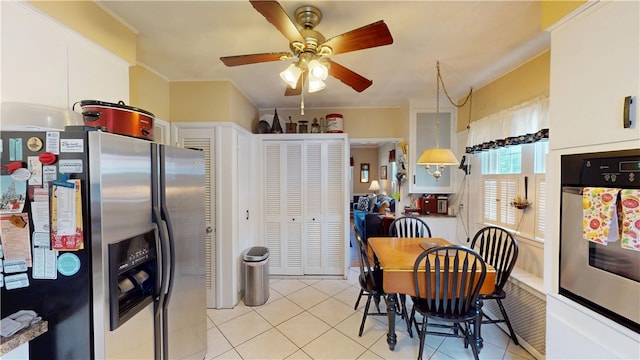 95 Burlington St, Providence, RI 02906 - kitchen with stainless steel appliances, light tile patterned flooring, a ceiling fan, and white cabinets