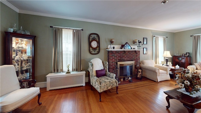 95 Burlington St, Providence, RI 02906 - living area featuring a brick fireplace, wood finished floors, and crown molding