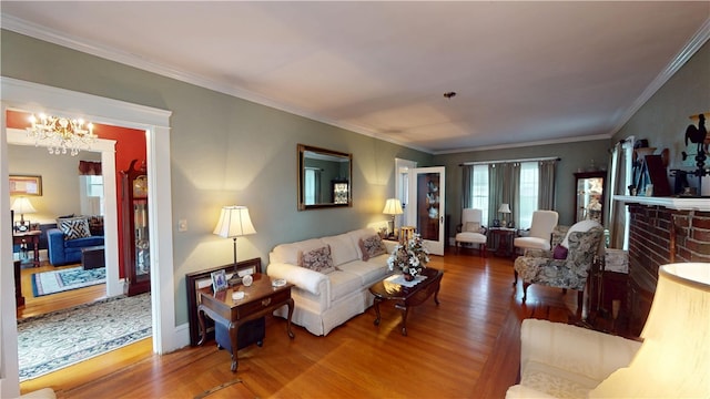 95 Burlington St, Providence, RI 02906 - living room featuring wood finished floors, healthy amount of natural light, a chandelier, ornamental molding, and a fireplace