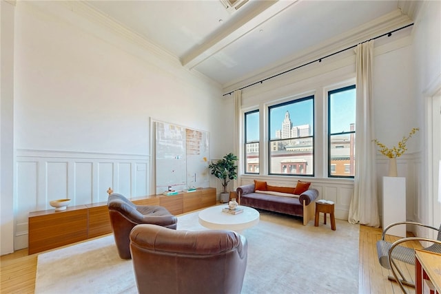 225 Weybosset St Unit 12, Providence, RI 02903 - living room featuring a decorative wall, light wood-style flooring, ornamental molding, beamed ceiling, and wainscoting
