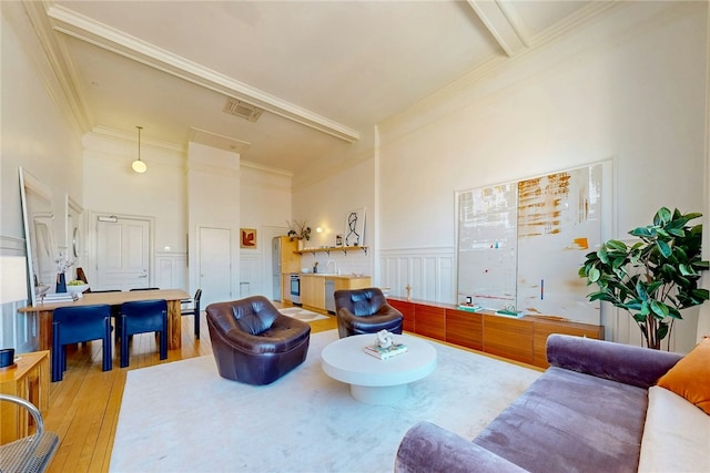 225 Weybosset St Unit 12, Providence, RI 02903 - living area with a towering ceiling, wood-type flooring, crown molding, and a wainscoted wall
