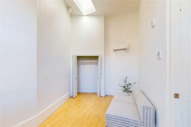 225 Weybosset St Unit 12, Providence, RI 02903 - hall with a skylight, light wood-style floors, and a wall unit AC