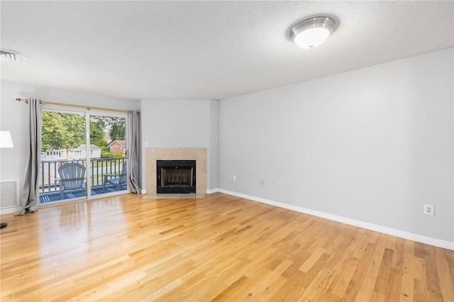 1800 Douglas Ave Unit 304, North Providence, RI 02904 - unfurnished living room featuring wood finished floors, a fireplace, and a textured ceiling