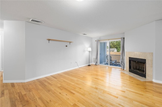 1800 Douglas Ave Unit 304, North Providence, RI 02904 - unfurnished living room featuring light wood finished floors and a tiled fireplace