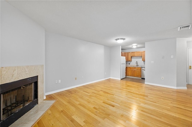 1800 Douglas Ave Unit 304, North Providence, RI 02904 - unfurnished living room featuring a premium fireplace and light wood finished floors