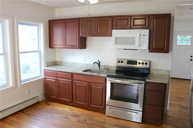 35 Merida Ave, Woonsocket, RI 02895 - kitchen featuring white microwave, electric range, a baseboard radiator, light wood-style flooring, and light stone counters