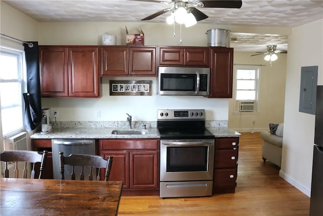 35 Merida Ave, Woonsocket, RI 02895 - kitchen with stainless steel appliances, a ceiling fan, electric panel, and light wood-type flooring