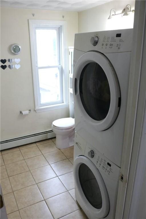 35 Merida Ave, Woonsocket, RI 02895 - bathroom featuring a baseboard heating unit, stacked washer / dryer, and tile patterned flooring