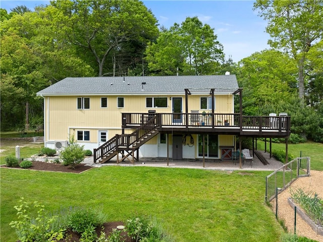 106 Lauri Dr, Charlestown, RI 02813 - rear view of house with a wooden deck, stairs, a lawn, a patio, and a shingled roof