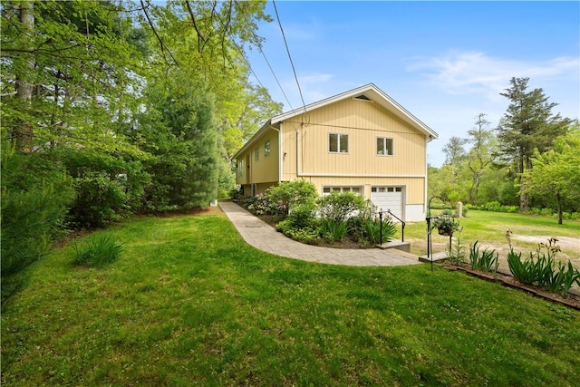 106 Lauri Dr, Charlestown, RI 02813 - view of side of property with a lawn and an attached garage