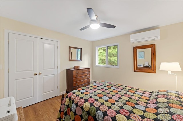 106 Lauri Dr, Charlestown, RI 02813 - bedroom featuring a wall unit AC, light wood-style floors, a closet, and a ceiling fan