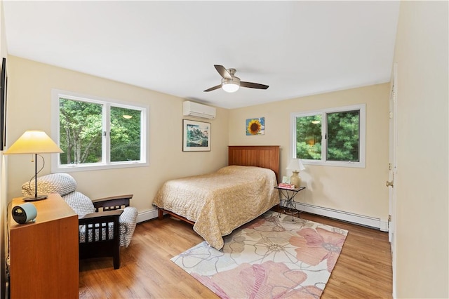 106 Lauri Dr, Charlestown, RI 02813 - bedroom with a baseboard heating unit, a wall unit AC, wood finished floors, and ceiling fan