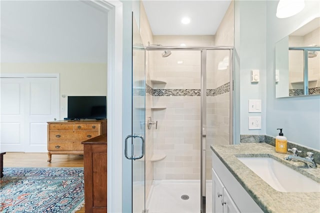 106 Lauri Dr, Charlestown, RI 02813 - bathroom with vanity, a shower stall, and wood finished floors