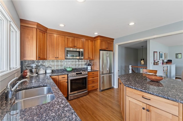 106 Lauri Dr, Charlestown, RI 02813 - kitchen with stainless steel appliances, light wood-type flooring, tasteful backsplash, dark stone counters, and recessed lighting