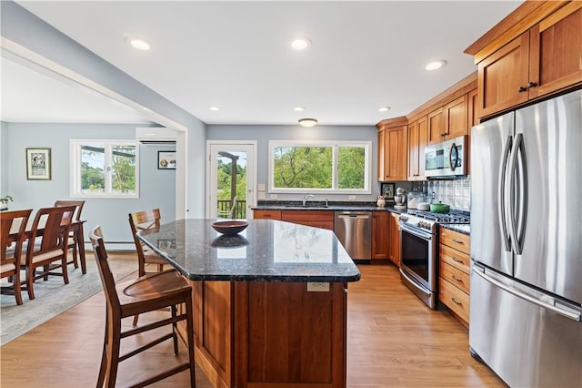 106 Lauri Dr, Charlestown, RI 02813 - kitchen featuring appliances with stainless steel finishes, a kitchen island, healthy amount of natural light, a wall mounted air conditioner, and recessed lighting