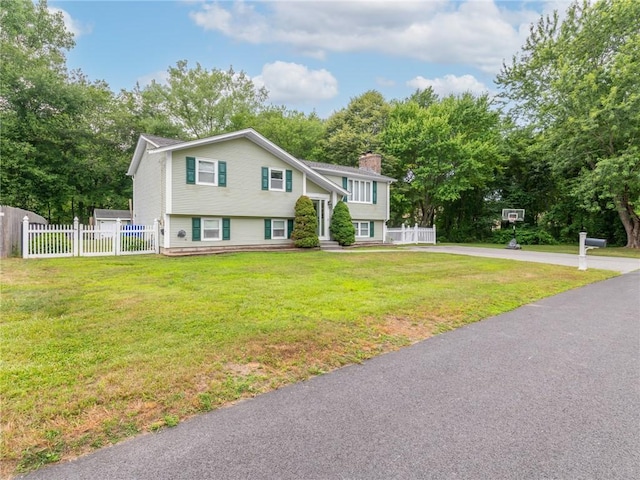 15 Sycamore Dr, West Warwick, RI 02893 - view of front of house featuring a chimney and view of scattered trees