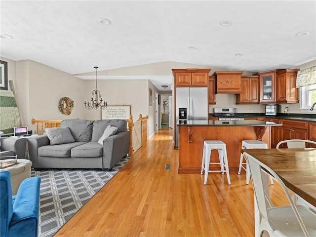 15 Sycamore Dr, West Warwick, RI 02893 - living room with light wood finished floors, vaulted ceiling, a chandelier, and recessed lighting