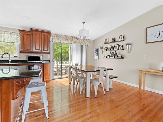 15 Sycamore Dr, West Warwick, RI 02893 - dining space featuring healthy amount of natural light, light wood-style flooring, and a chandelier