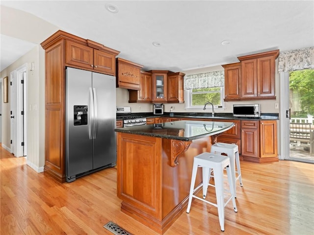 15 Sycamore Dr, West Warwick, RI 02893 - kitchen featuring appliances with stainless steel finishes, light wood-style floors, brown cabinets, plenty of natural light, and recessed lighting