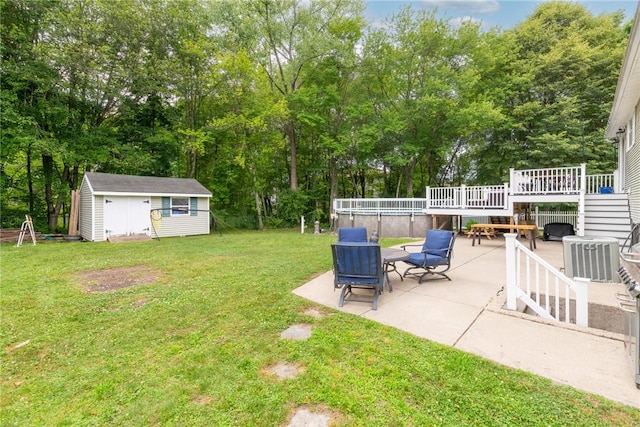 15 Sycamore Dr, West Warwick, RI 02893 - view of green lawn featuring a patio area, a storage shed, a deck, and view of wooded area