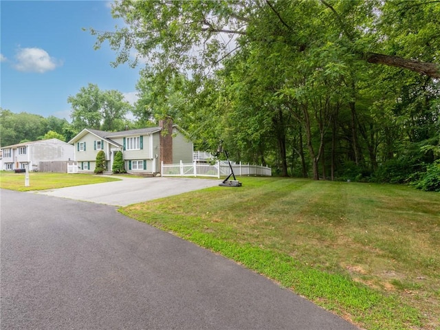 15 Sycamore Dr, West Warwick, RI 02893 - view of front of property featuring asphalt driveway and a chimney