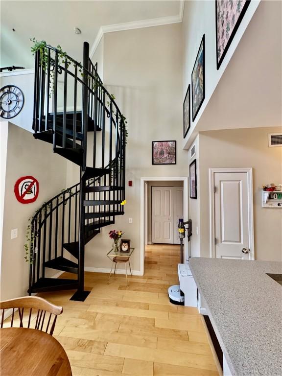 1000 Providence Pl Unit 449, Providence, RI 02903 - staircase with a high ceiling, ornamental molding, and wood finished floors