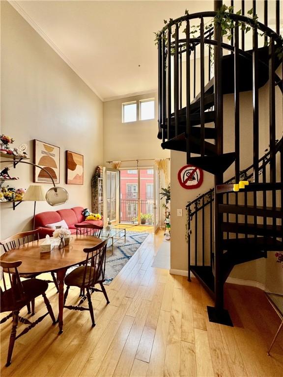 1000 Providence Pl Unit 449, Providence, RI 02903 - dining room with hardwood / wood-style floors, stairs, crown molding, and a towering ceiling
