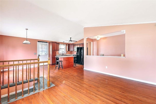 28 Plant St, Cumberland, RI 02864 - kitchen featuring black fridge, light wood finished floors, vaulted ceiling, a ceiling fan, and a kitchen island