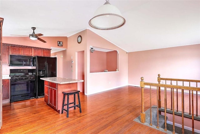 28 Plant St, Cumberland, RI 02864 - kitchen featuring black appliances, vaulted ceiling, a center island, ceiling fan, and light wood-style flooring
