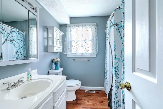 28 Plant St, Cumberland, RI 02864 - bathroom featuring vanity, wood finished floors, a textured ceiling, and a shower with shower curtain