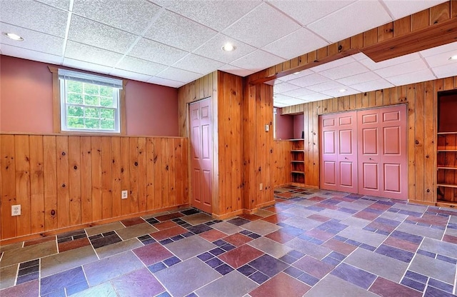 28 Plant St, Cumberland, RI 02864 - below grade area with wood walls, a paneled ceiling, and wainscoting