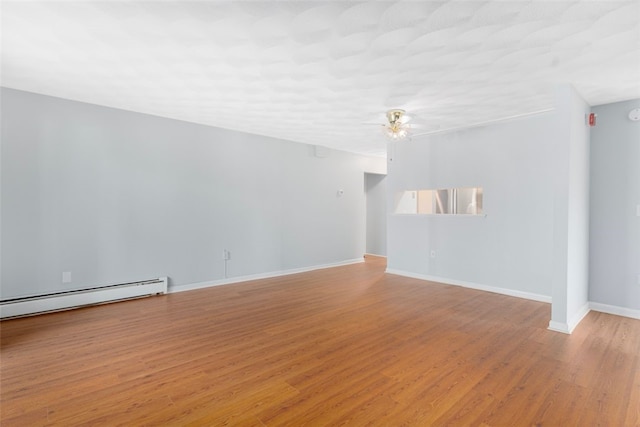 750 Quaker Ln Unit B112, Warwick, RI 02818 - unfurnished room featuring a baseboard radiator, ceiling fan, and light wood finished floors