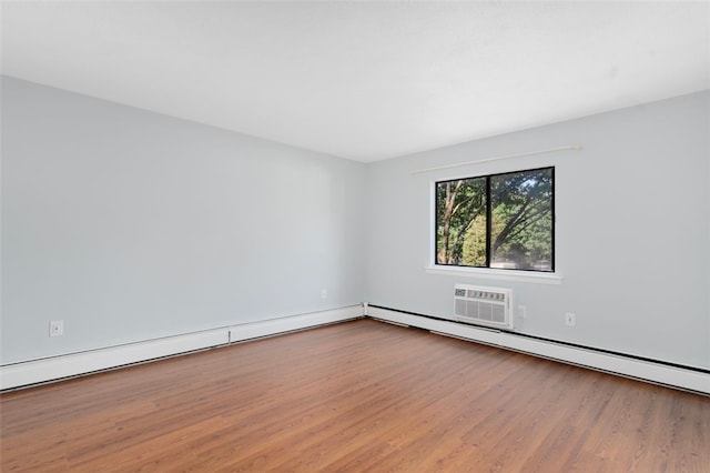 750 Quaker Ln Unit B112, Warwick, RI 02818 - spare room featuring wood finished floors, a baseboard heating unit, and a wall mounted air conditioner