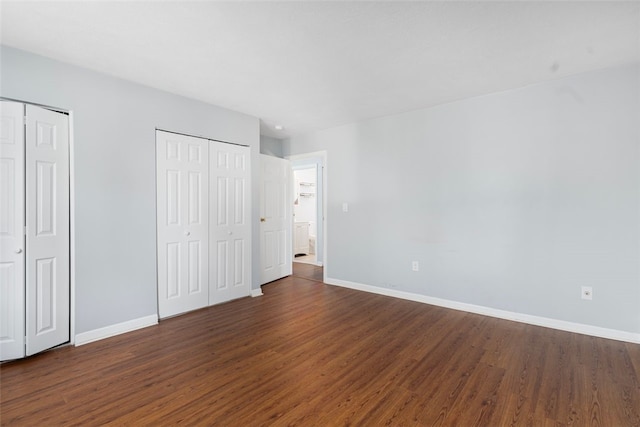 750 Quaker Ln Unit B112, Warwick, RI 02818 - unfurnished bedroom with two closets and dark wood finished floors