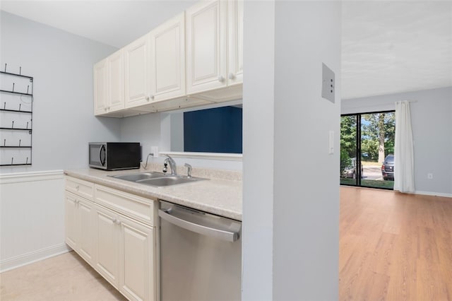 750 Quaker Ln Unit B112, Warwick, RI 02818 - kitchen with dishwasher, black microwave, light countertops, white cabinets, and light wood-style flooring