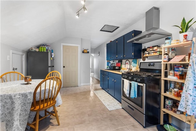 38 Vine St, East Providence, RI 02914 - kitchen with appliances with stainless steel finishes, island exhaust hood, blue cabinets, vaulted ceiling, and light countertops