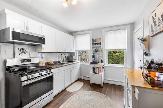 38 Vine St, East Providence, RI 02914 - kitchen featuring stainless steel appliances, a baseboard radiator, butcher block counters, and dark wood finished floors