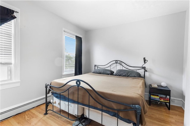 38 Vine St, East Providence, RI 02914 - bedroom featuring a baseboard heating unit and wood finished floors