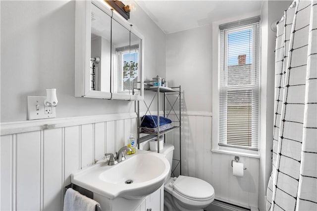 38 Vine St, East Providence, RI 02914 - bathroom with wainscoting, plenty of natural light, vanity, and baseboard heating