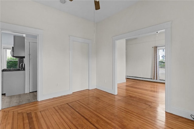 230 Pawtucket Ave, Pawtucket, RI 02860 - spare room with baseboard heating, a ceiling fan, and wood finished floors