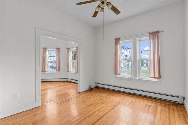 230 Pawtucket Ave, Pawtucket, RI 02860 - empty room featuring a baseboard heating unit, healthy amount of natural light, and light wood finished floors