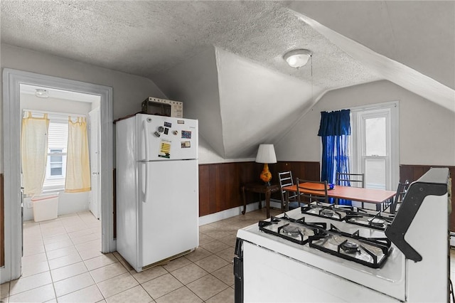 230 Pawtucket Ave, Pawtucket, RI 02860 - kitchen with white appliances, vaulted ceiling, a textured ceiling, a wainscoted wall, and wooden walls